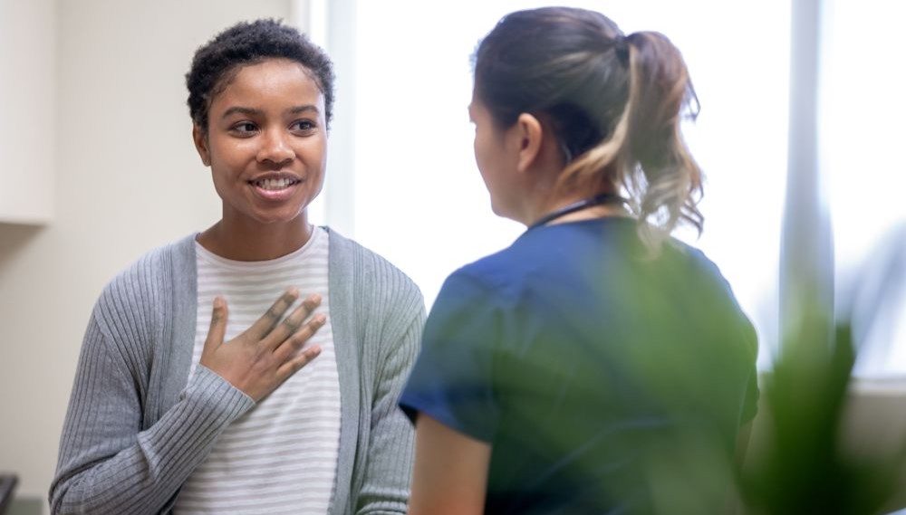 A woman talks with her doctor.