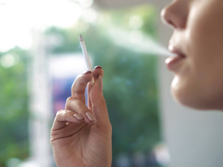 closeup of woman smoking a cigarette